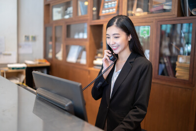 Receptionist answering the phone in a hotel