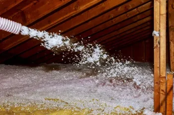 Insulation being spread in an attic - Magic Exterminating in Flushing NY