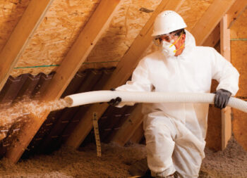 a licensed new york installer adding TAP pest control insulation to an attic